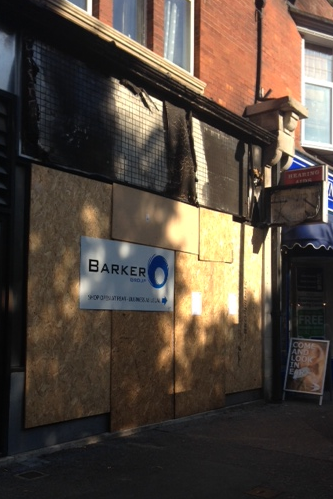 Photo of Barkers Dry-Cleaning after being boarded up.