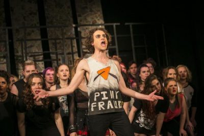 A photograph of cast members performing in American Idiot