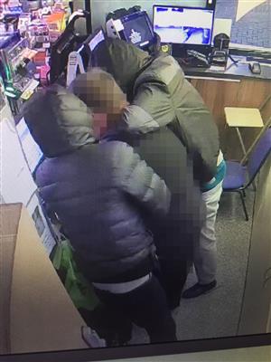 a CCTV image of two men robbing a petrol station in Bournemouth