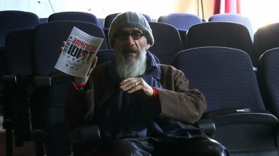 An image of Tony Kaye holding the programme of American Idiot