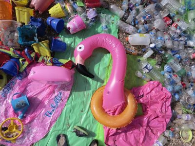 Photo of inflatable flamingo, plastic bottles and lilos left on Bournemouth beach