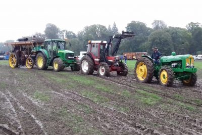 Three tractors towing a nine ton steam engine out of the mud