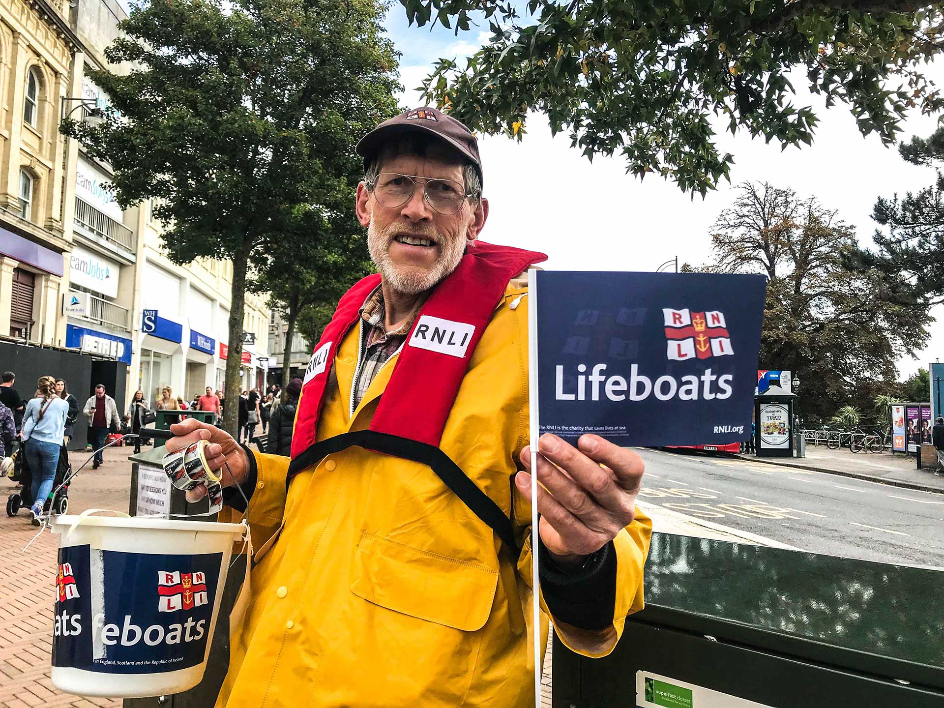 David Cox, with his Lifeboats basket and flag, always keep his smile and warmly welcome the passers-by on the street