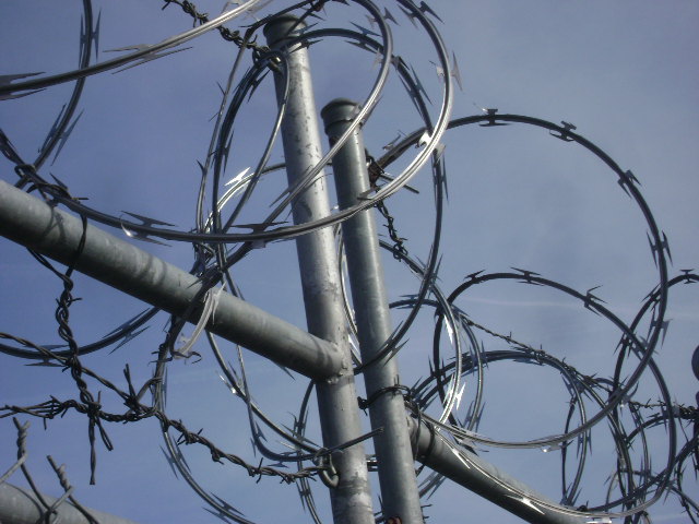 Image of razor wire outside a prison