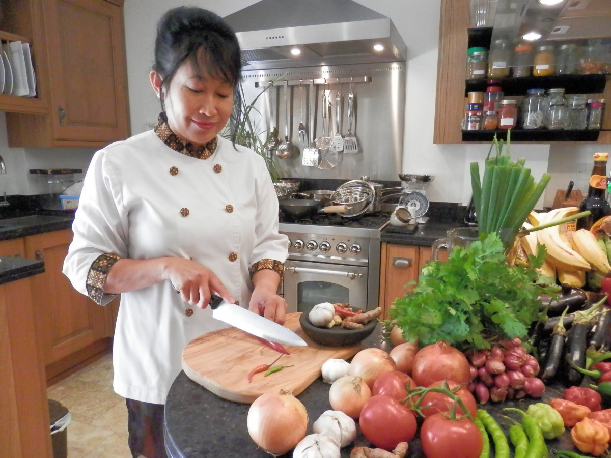 Yayu Slocock chopping chillies in her kitchen.Photo: Rebecca Land