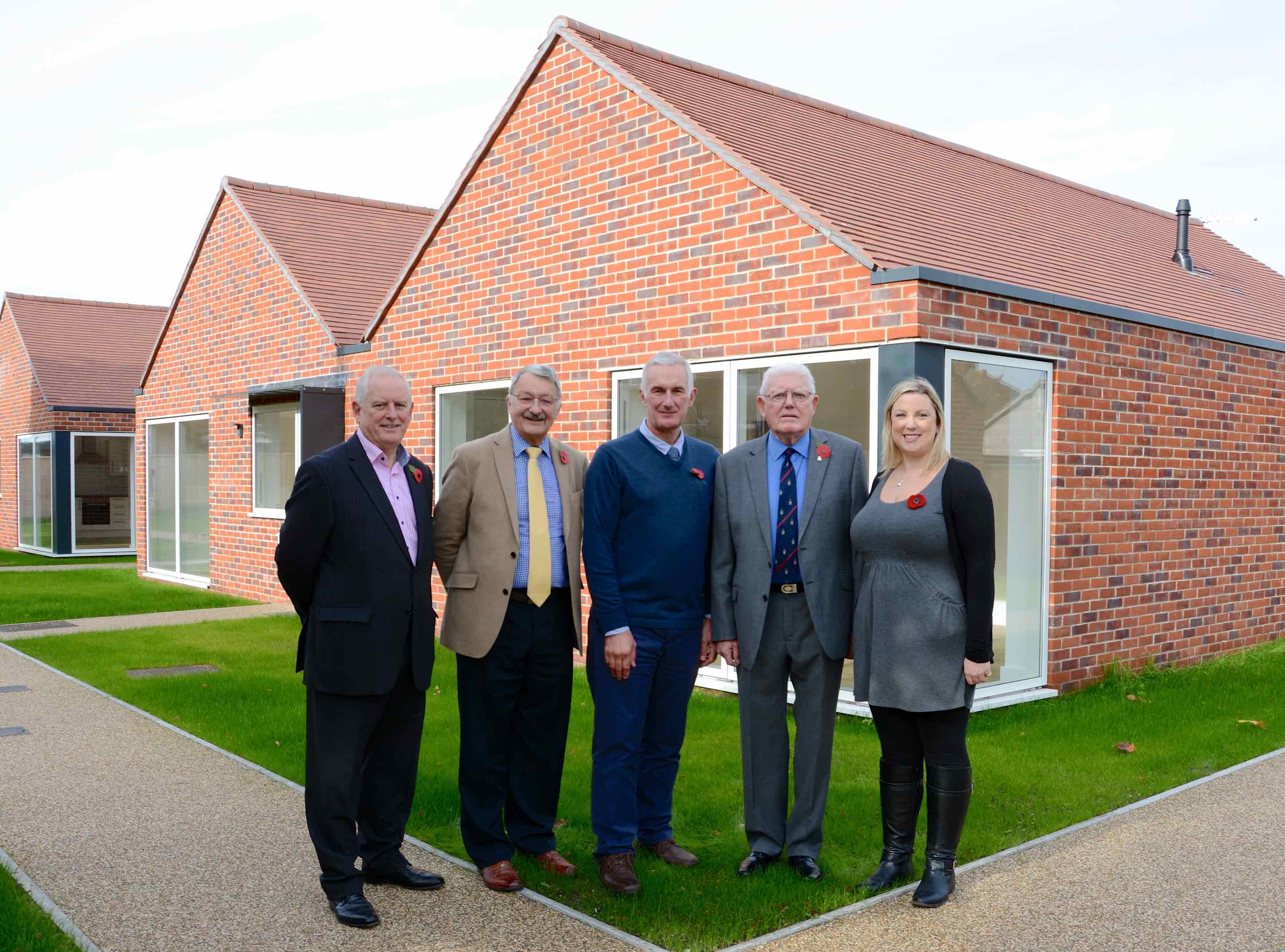 Photo of Gordon Long, Peter Matthews, Ricardo Cobelli, Alan Davies, Sophie Burgess-Kennar outside new bungalows