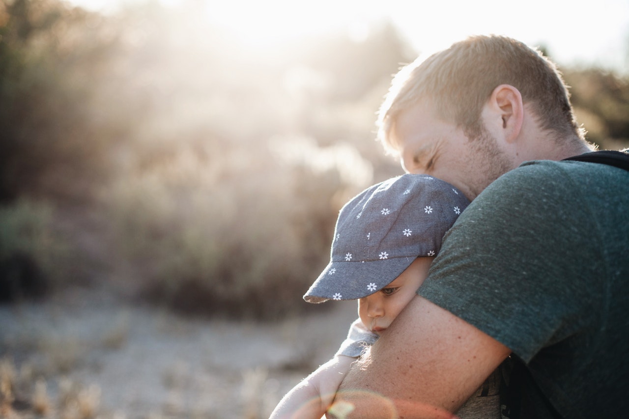 Photo of a father holding his baby