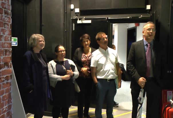 Kate Adie stands with BU staff in TV studio