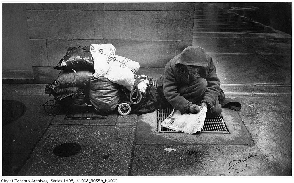 Homeless man doing crossword