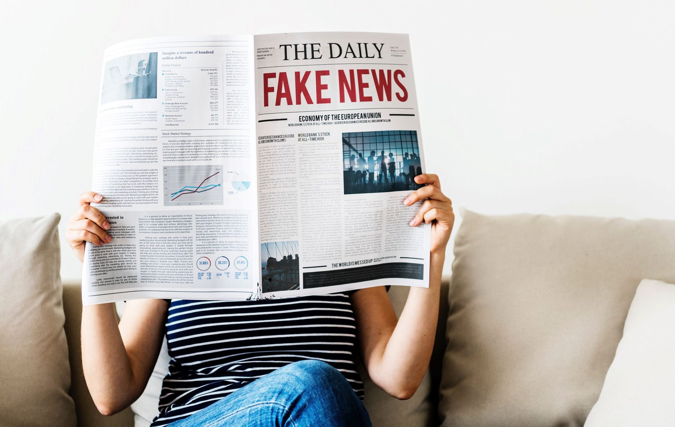 Photograph of Woman reading newspaper with Fake News Headline