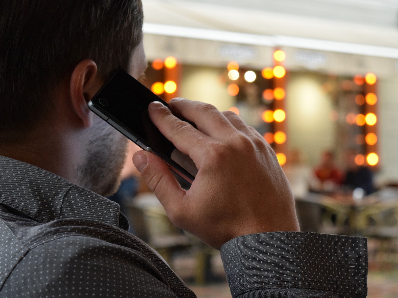 man stood with phone to ear