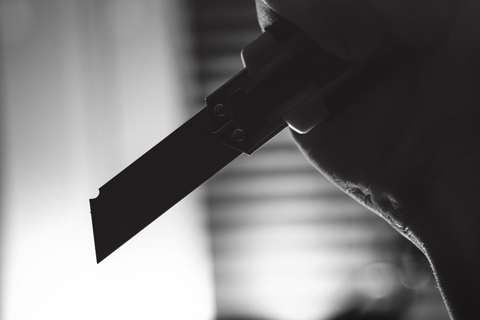 black and white pictures of someone holding a knife