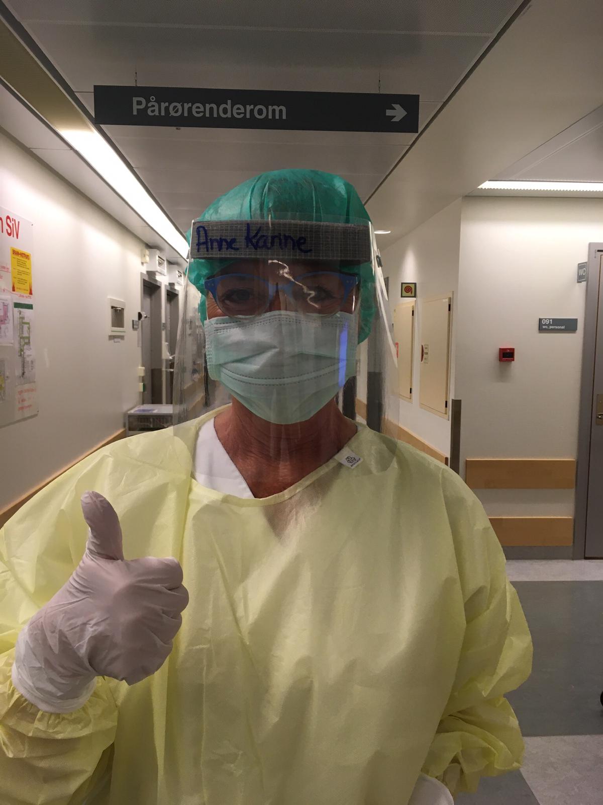 Protective gear could be sweaty for some nurses, but Anne Karine Swanstroem is in a good mood.