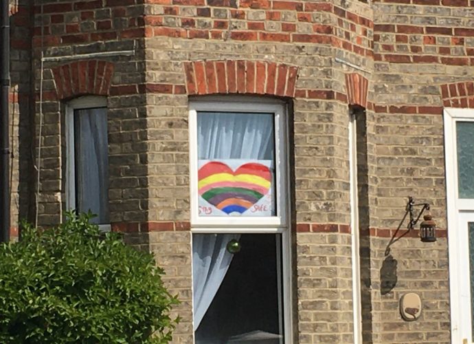 An image of a rainbow heart in a window