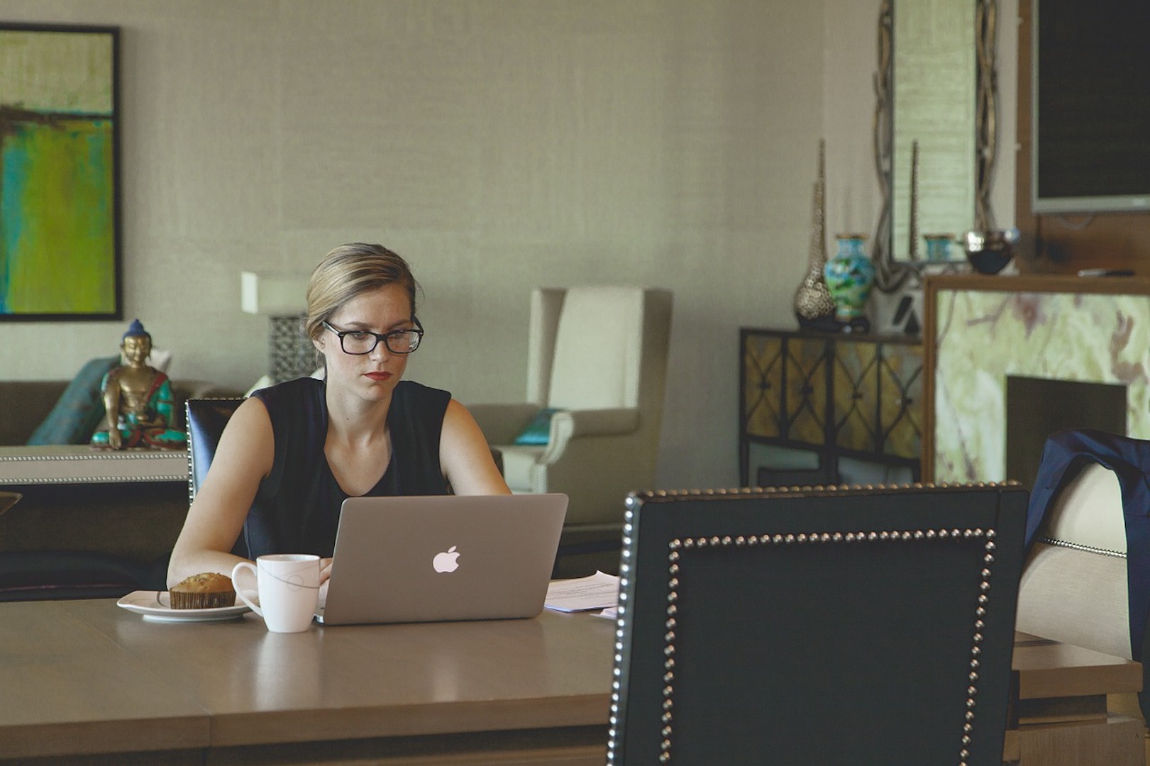 Woman working from the dinning table at home