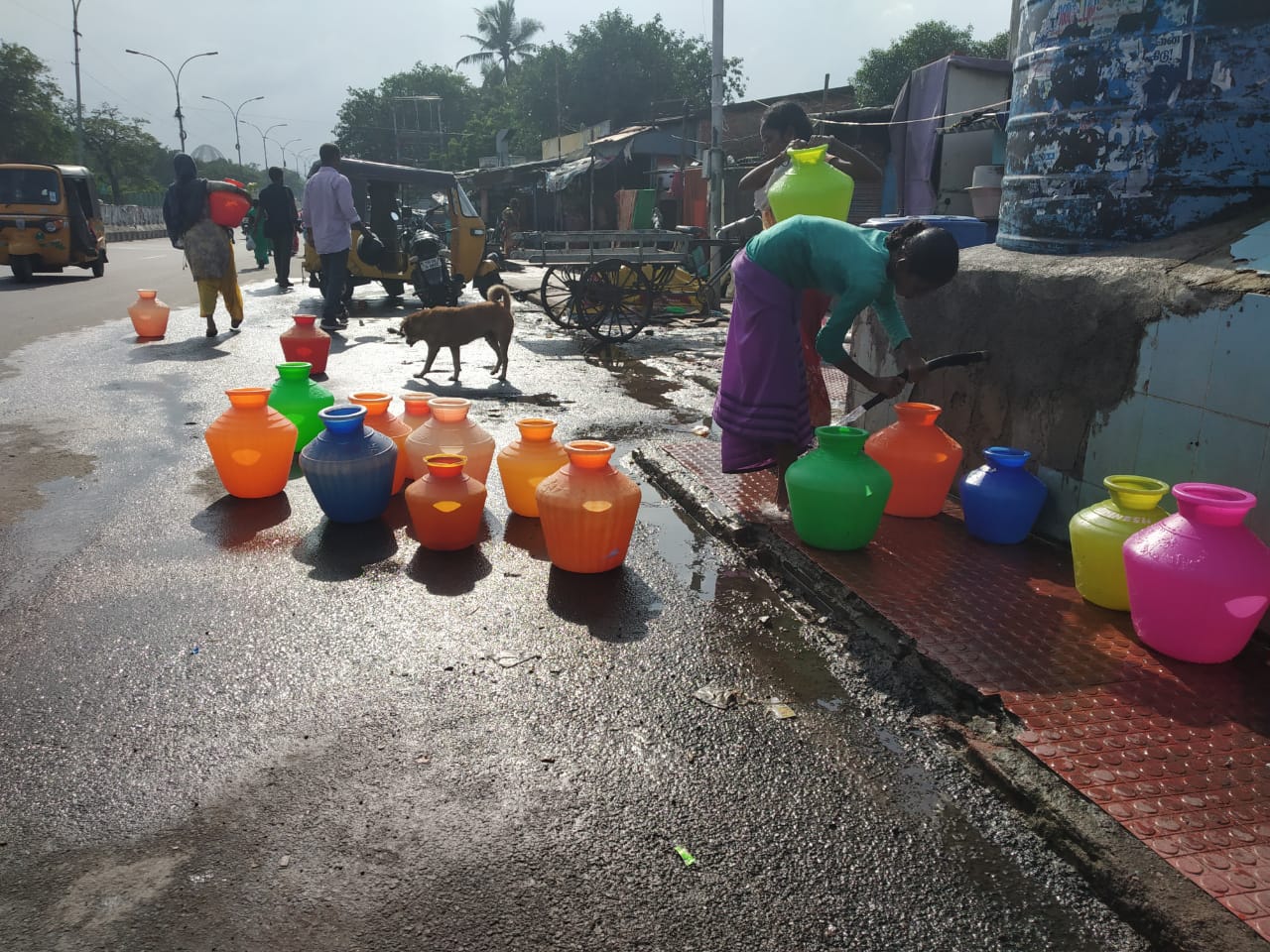 People collecting water from public water tanks