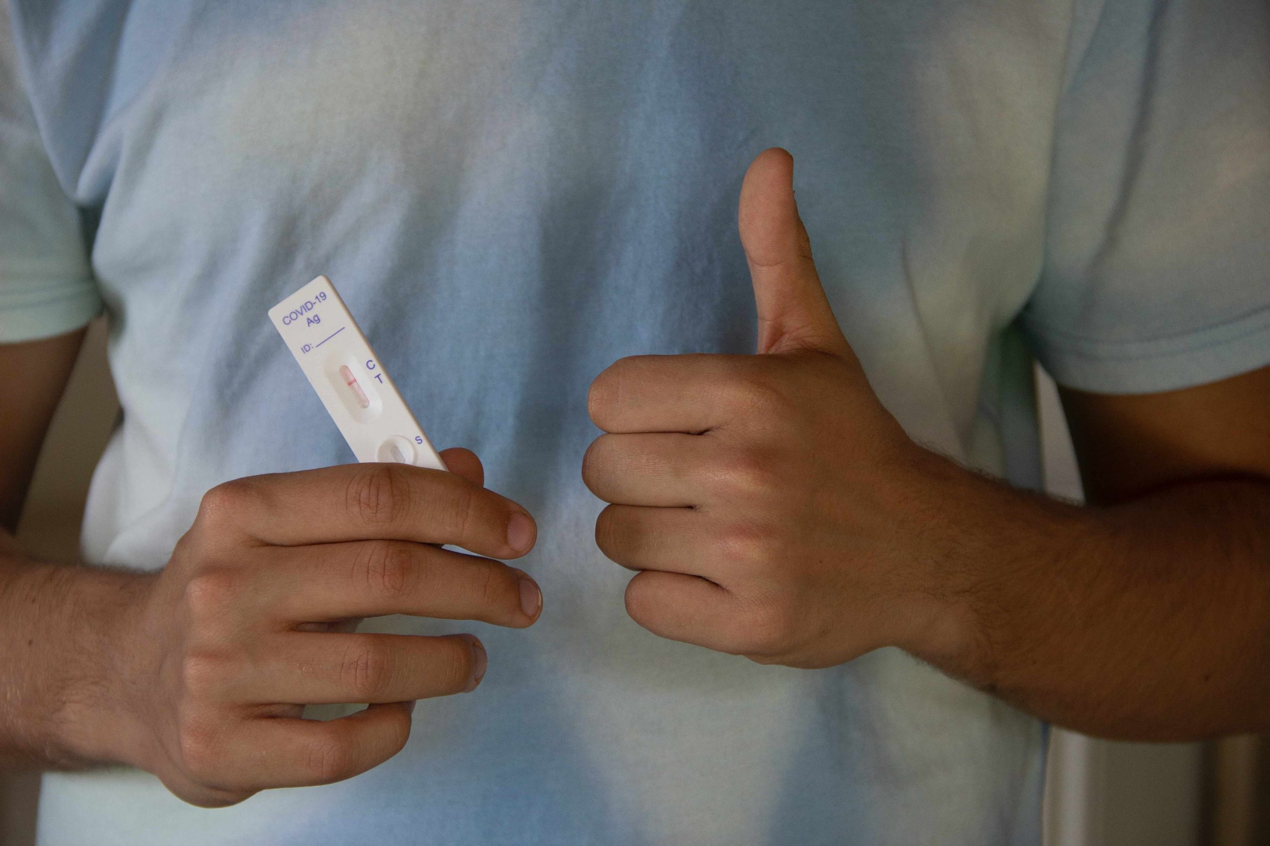 Person showing thumbs up for a negative Covid-19 Test