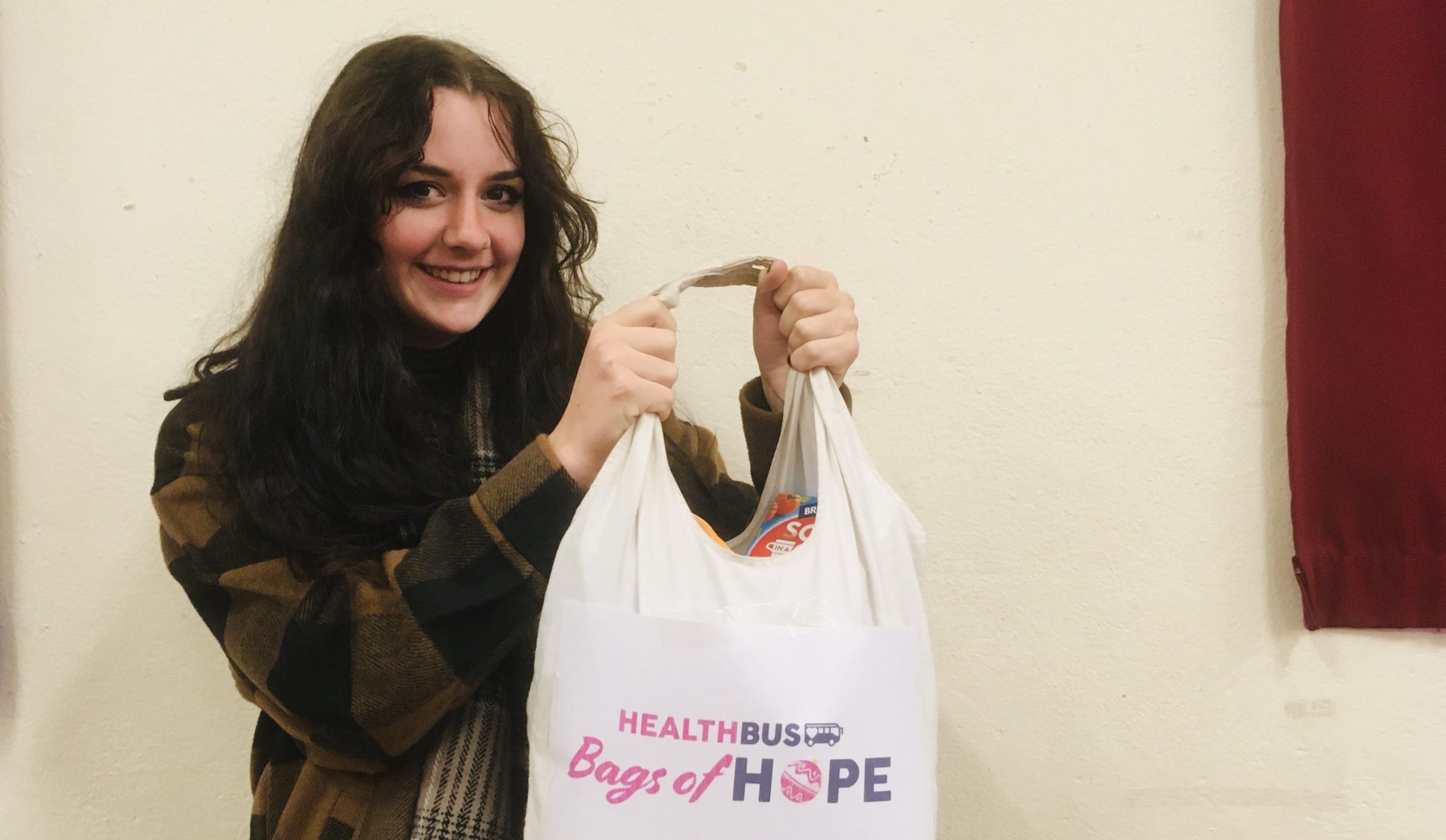 picture of a volunteer holding up a gift bag