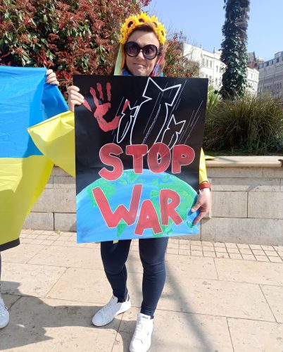 A woman holding a placard saying 'Stop War'