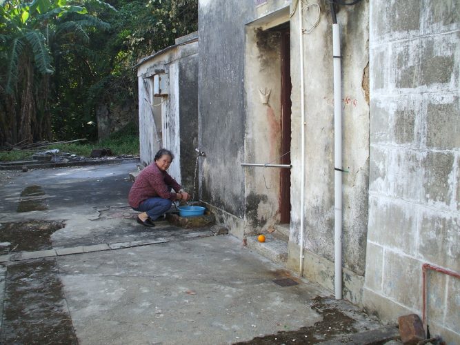 Kwan outside the house where she raised her family in San Tau Village, Hong Kong