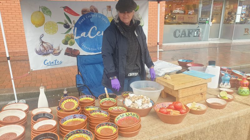 Vendor shows how utensils can be used for Vegan meals