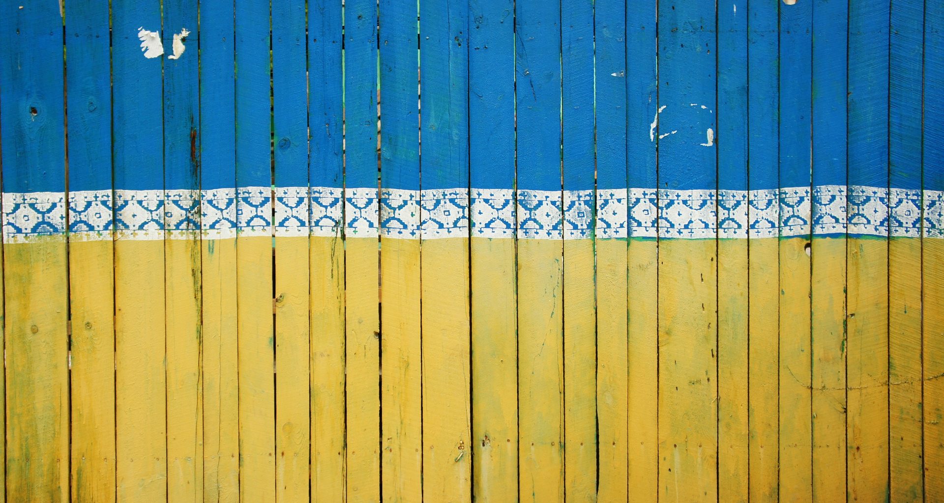 A fence painted the colours of the Ukrainian flag