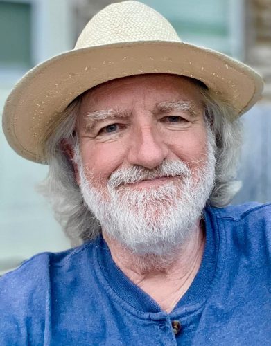 Photo of a man in a hat, smiling