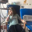 Photo of a young girl in a hospital chair wired up to a machine as she is very unwell.