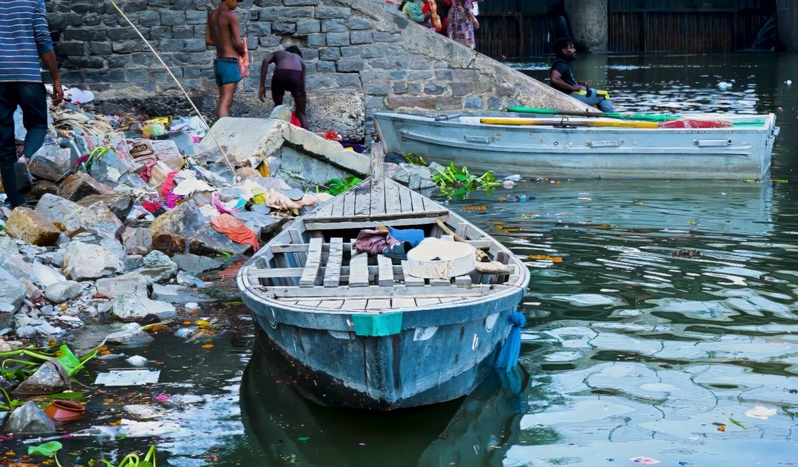 A boat on the bank of the polluted Yamuna River