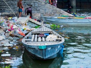 A boat on the bank of the polluted Yamuna River