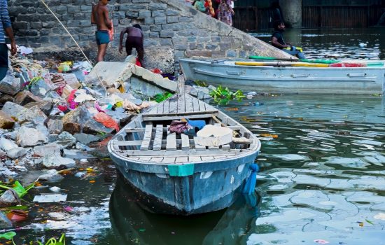 A boat on the bank of the polluted Yamuna River