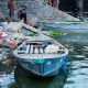 A boat on the bank of the polluted Yamuna River
